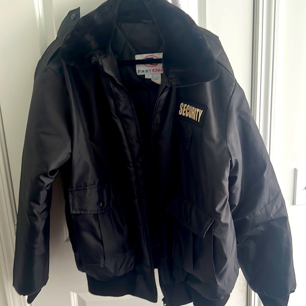 Black heavy duty zip up security jacket with fur neck two side pockets.